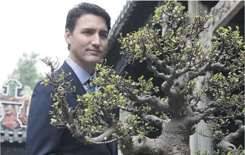  ?? SEAN KILPATRICK/THE CANADIAN PRESS ?? Prime Minister Justin Trudeau is given a tour of the Chen Clan Academy in Guangzhou, China, on Thursday.