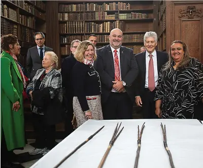  ?? (Cambridge University via AP) ?? Undated handout photo issued by Cambridge University of Elisabeth Bowes, Leonard Hill, Stephen Smith and Noeleen Timbery with four Aboriginal spears that were brought to England by Captain James Cook more than 250 years ago and have now been repatriate­d to Australia in a ceremony Tuesday at Trinity College in Cambridge.