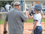  ?? Scott Herpst ?? E.G. Hixon gets a fist bump from first base coach Kevin McElhaney after a solid single in Gordon Lee’s home game against LaFayette this past Wednesday. The freshman is hitting .786 (11 of 14) in her first five games to help the Lady Trojans to a 5-0 start.