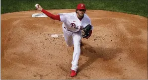  ?? MATT SLOCUM —
THE ASSOCIATED PRESS ?? Phillies pitcher Aaron Nola uncorks some midseason stuff on Opening Day while setting the Braves down 1-2-3in the first inning Thursday at Citizens Bank Park