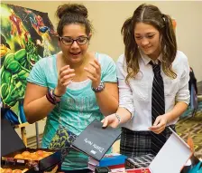  ?? Gazette file photo ?? n Kaitlyn Salazar and Destiny Hoipkemier browse through the offerings at last year’s Ark-La-Tex Comic Con. The Comic Con returns this weekend to the Texarkana Convention Center.