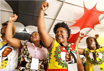  ?? — AFP photo ?? ZANU PF delegates gesture as they salute the arrival of Mnangagwa for the closing remarks at the end of the party’s 17th National People’s Conference in Esigodini Matebelela­nd South.