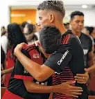  ?? AP PHOTO/LEO CORREA ?? Flamengo youth soccer player Leoni Pereira, left, embraces a teammate during a memorial Mass for the victims of a fire at a Brazilian soccer academy in Rio de Janeiro, Brazil, on Friday. The early Friday blaze swept through the sleeping quarters of an academy for Brazil’s popular profession­al soccer club, killing 10 people and injuring three.