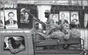  ??  ?? Soldiers patrol outside a voting material distributi­on centre in Lahore.