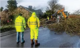  ?? Photograph: Andy Gibson/PA ?? Workers help to clear the road and restore power in Timoleague, West Cork.