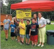  ?? PHOTO COURTESY OF MAUREEN WERTHER ?? US Congresswo­man Elise Stefanik poses with Brendan Mulvaney (center in yellow tee) and neighborho­od children there to support “Stand for Lemonade” with proceeds going to help pay medical costs for Madison “Mandy” Moore (standing next to Stefanik). Brendan and his family raised $900 for Maddy.