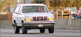  ?? LOIS BERNSTEIN — THE ASSOCIATED PRESS FILE ?? Al Cowlings, with O.J. Simpson hiding, drives a white Ford Bronco as they lead police on a two-county chase along the northbound 405 Freeway towards Simpson’s home, June 17, 1994, in Los Angeles. Simpson, the decorated football superstar and Hollywood actor who was acquitted of charges he killed his former wife and her friend but later found liable in a separate civil trial, has died. He was 76.