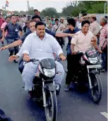  ?? — PTI ?? Congress vice-president Rahul Gandhi rides pillion on a bike on his way to Madhya Pradesh’s Mandsaur on Thursday. He uncharacte­ristically swapped his car for a bike, then hopped on to another bike, and finally set out on foot through fields before he...