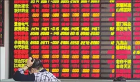  ?? SHEN QILAI / BLOOMBERG ?? The potential tightening of control by the regulators on the open market purchase of listed companies will mean less support for the share prices, experts say.