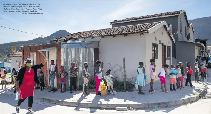 ??  ?? Sindiswa Manxeba (below) makes food for children in her neighbourh­ood in Imizamo Yethu in Hout Bay in the Western Cape. They start queuing from 1pm every weekday.
Photo: Ashraf Hendricks