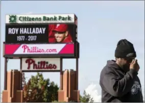  ?? MATT ROURKE — THE ASSOCIATED PRESS ?? Michael Aikens crosses himself as he pays his respects outside Citizens Bank Park at a makeshift memorial for former Phillies pitcher Roy Halladay in Philadelph­ia, Wednesday.