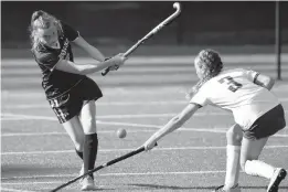  ?? BRIAN KRISTA/CAPITAL GAZETTE ?? Chesapeake’s Natalie Forman, left, sends the ball over the stick of Old Mill’s Emma Shelton during Tuesday’s game.