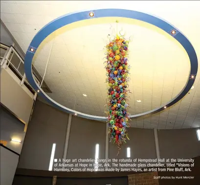  ?? Staff photos by Hunt Mercier ?? A huge art chandelier hangs in the rotunda of Hempstead Hall at the University of Arkansas at Hope in Hope, Ark. The handmade glass chandelier, titled “Visions of Harmony, Colors of Hope” was made by James Hayes, an artist from Pine Bluff, Ark.