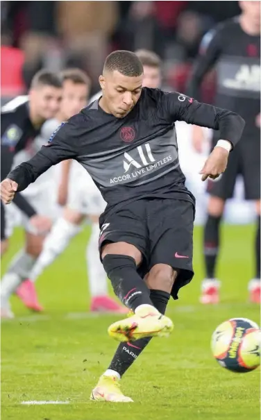  ?? Associated Press ?? PSG’S Kylian Mbappe scores a penalty during their French League match against Angers in Paris on Friday.