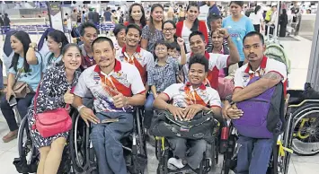  ??  ?? Thai Paralympic athletes pose with their families at Suvarnabhu­mi airport before flying to Rio yesterday.