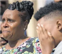  ?? PHOTO / AP ?? Tirzah Patterson, former wife of Buffalo shooting victim Heyward Patterson, speaks as her son, Jaques “Jake” Patterson, 12, covers his face during a press conference.