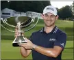  ?? BRYNN ANDERSON — THE ASSOCIATED PRESS ?? Patrick Cantlay poses with the trophy after winning the Tour Championsh­ip golf tournament and the FedEx Cup at East Lake Golf Club, Sunday, in Atlanta.