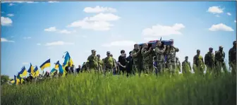  ?? (AP/Francisco Seco) ?? Ukrainian soldiers carry the coffin of Volodymyr Losev, 38, on May 16 during his funeral in Zorya Truda in the Odesa region of Ukraine. The 38-year-old Ukrainian volunteer soldier was killed May 7 when the military vehicle he was driving ran over a mine in eastern Ukraine.