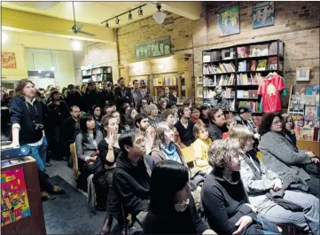  ?? PIERRE OBENDRAUF/ GAZETTE FILES ?? An audience listens to a speaker at Drawn & Quarterly, which hosts about 75 readings and launches a year. This Sunday, Adrian Tomine, Charles Burns and Chris Ware speak at the fifth-anniversar­y event at the Ukrainian Federation.