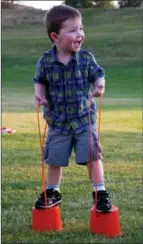  ?? BARB AGUIAR/Westside Weekly ?? Torsten Godwin, 2, grins as he masters the stilts for the first time at last Friday’s Music in the Park. Torsten and his family are regulars at the event. They like all the play equipment set up for families and the cool atmosphere with the music.