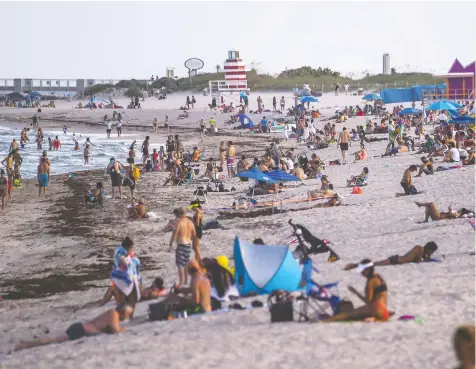  ?? CHANDAN KHANNA / AFP VIA GETTY IMAGES ?? People relax in Florida's Miami Beach, one of the top spots for Canadian snowbirds.