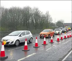  ?? ?? The busy roundabout reduced to one lane