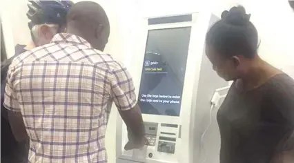  ??  ?? Customers transact on a Golix ATM recently