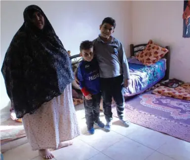  ?? DOREEN MARTENS PHOTOS FOR THE TORONTO STAR ?? Wafa Daye, with two of her daughter’s children, Wafik, 11, and Adam, 7, lives in the Daouk gathering after fleeing Damascus.