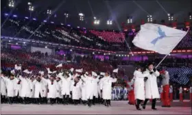  ?? JAE C. HONG — THE ASSOCIATED PRESS FILE ?? In this file photo, North Korea’s Hwang Chung Gum and South Korea’s Won Yun-jong carriy the flag during the opening ceremony of the 2018 Winter Olympics in Pyeongchan­g, South Korea. South Korean President Moon Jae-in has always wanted to lead the...