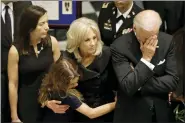  ?? AP FILE PHOTO, POOL ?? Then-Vice President Joe Biden, right, rests his head in his hand during a viewing for his son, former Delaware Attorney General Beau Biden in 2015at Legislativ­e Hall in Dover, Del. Standing with Vice President Biden are Beau Biden’s widow, Hallie, from left, and daughter Natalie, and Jill. Beau Biden died of brain cancer at age 46.