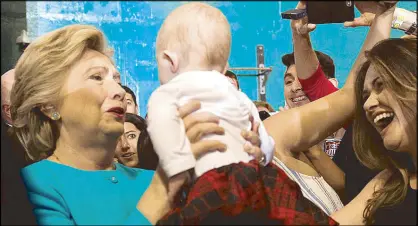  ?? AFP ?? Democratic presidenti­al nominee Hillary Clinton holds a baby at a rally in Lake Worth, Florida Wednesday.