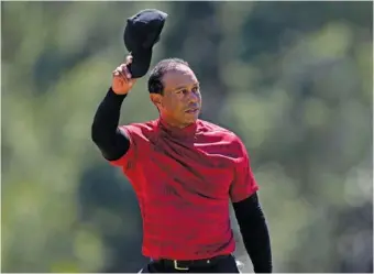  ?? AP PHOTO/JAE C. HONG ?? Tiger Woods tips his cap on the 18th green during the final round of the Masters last April in Augusta, Ga. Woods, who has five green jackets among his 15 major championsh­ips, will be back at the Masters when the first major of the year tees off Thursday in Georgia.