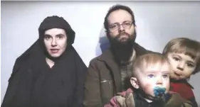  ?? TALIBAN MEDIA VIA AP ?? In this still from a video released by Taliban Media in December 2016, Caitlan Coleman talks while her Canadian husband, Joshua Boyle, holds their two children. Coleman was pregnant when she was captured. The couple had three children while in...