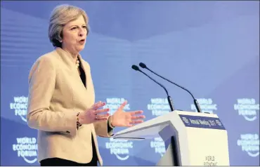  ?? PHOTO: AP ?? British Prime Minister Theresa May speaks at the World Economic Forum in Davos in this file photo. She wants to see “sector deals” to identify and address barriers to expansion in different industries.