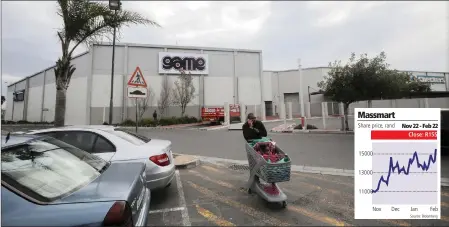  ?? PHOTO: REUTERS ?? A man walks past an outlet of the Massmart-owned Game Stores in Cape Town. The group’s market share in durable department­s continued to increase.