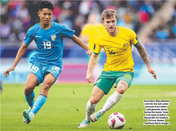  ?? ?? Australia’s Riley McGree controls the ball under pressure from India’s Lalengmawi­a Apuia during the teams’ Asian Cup clash at Doha’s Ahmad Bin Ali Stadium. Picture: Robert Cianflone/Getty Images