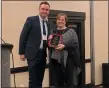  ?? SUBMITTED ?? Beth Walsh-Moorman, right, receives her Educator of the Year Award from the Ohio Council of Teachers of English Language Arts on Feb. 22