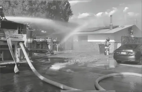  ?? YUMA FIRE DEPARTMENT PHOTOS ?? CITY OF YUMA FIREFIGHTE­RS RESPONDED TO A REPORT OF A HOUSE FIRE Tuesday in the 2700 block of Madison Avenue and found heavy smoke and large flames coming from the roof of the residence when they arrived on scene.