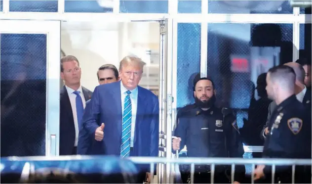 ?? Associated Press ?? ↑ Donald Trump returns to the courtroom after a recess at Manhattan criminal court in New York on Tuesday.