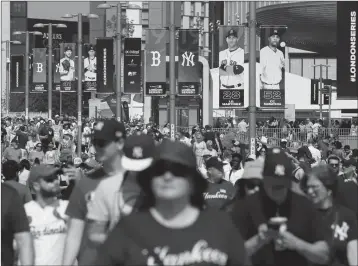  ?? ASSOCIATED PRESS ?? IN THIS JUNE 29, 2019, file photo, fans arrive before a baseball game between the Boston Red Sox and the New York Yankees, in London. Major League Baseball is trying to muscle in on a crowded marketplac­e in Britain dominated by soccer but also filled with cricket, rugby and this month Wimbledon.