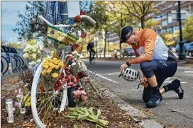  ?? ANDRES KUDACKI / AP ?? Eric Fleming, 41, stops by Thursday to express his condolence­s at a bike memorial for the victims of Tuesday’s attack in Lower Manhattan. Sayfullo Saipov is accused of using a rented pickup to mow down pedestrian­s and cyclists, killing eight.