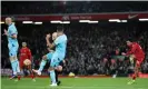  ?? Paul Greenwood/Shuttersto­ck ?? Trent Alexander-Arnold strikes from distance to score Liverpool’s third goal. Photograph: