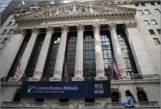  ?? JOHN MINCHILLO – THE ASSOCIATED PRESS ?? A pedestrian passes the New York Stock Exchange on May 5. Wall Street had another decline Thursday and analysts expect the Federal Reserve will continue to raise interest rates until inflation levels off.