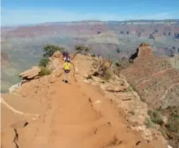  ?? ANNA JOHNSON/THE ASSOCIATED PRESS ?? A group makes its way along a ridgeline on the Grand Canyon National Park’s South Kaibab trail. Hiking to the canyon floor can take four to six hours.