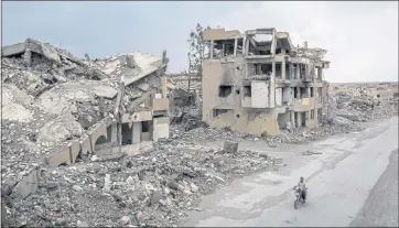  ?? IVOR PRICKETT — THE NEW YORK TIMES ?? Ruins in the Syrian city of Raqqa are seen in 2018, where Islamic State ruled from for three years before being driven out. A number of towns, including Raqqa, were reduced to little more than rubble during the U.S. air campaign against the Islamic State militants in northern Syria.