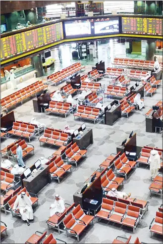  ?? Photo by Bassam Abo Shanab ?? File photo shows traders on Boursa Kuwait floor. Thursday trading ends in red zone. — See Page 35