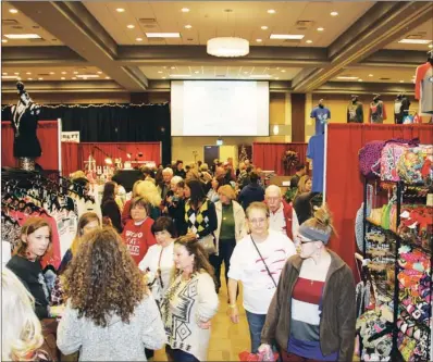  ??  ?? Above: Some of the more than 6,000 shoppers who attended the 4th annual Glitz & Glamour browse through the Benton Event Center while looking at the offerings of 60 vendors. Right: Kinslee Bagley, 3, tries to convince her mom that she really needs a...