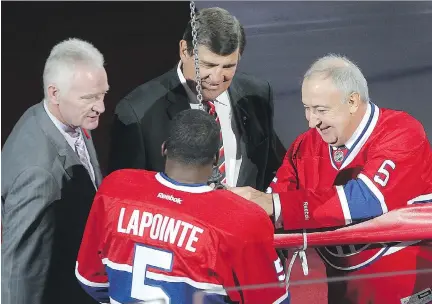  ?? PIERRE OBENDRAUF/FILES ?? First choice: Larry Robinson, left, with Serge Savard and P.K. Subban at the Bell Centre jersey retirement ceremony of Guy Lapointe, right, in 2014. The Canadiens cancelled a job interview with Robinson in 2012 and instead hired J.J. Daigneault as an...