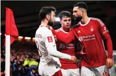  ?? — AFP photo ?? Nottingham Forest’s defender Felipe (right) holds Manchester United’s midfielder Fernandes by the neck, but does not receive a card, during the English FA Cup fifth round match at The City Ground, in Nottingham, central England.