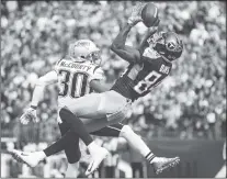  ?? AP PHOTO ?? Tennessee Titans wide receiver Corey Davis drops a pass in the end zone while covered by New England Patriots cornerback Jason Mccourty during Tennessee’s 34-10 win over New England on Sunday in Nashville.